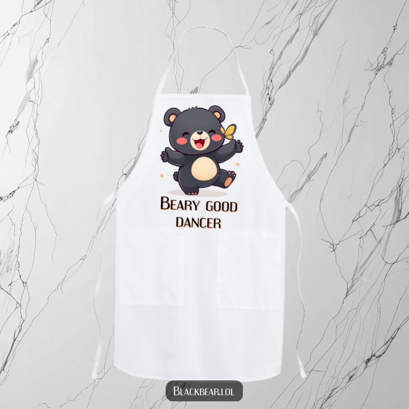 Funny apron showing a black bear cub doing a happy dance with a butterfly, ready for culinary adventures.