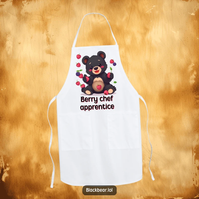 Funny Apron print of a black bear cub hilariously juggling berries, ideal for adding humor to kitchen tasks.
