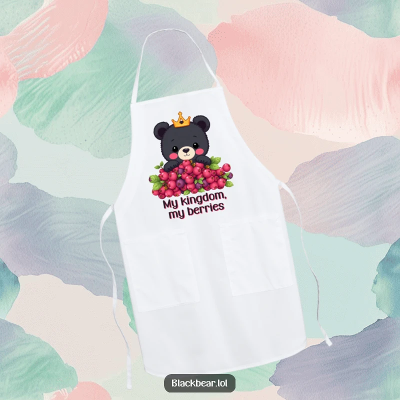 Funny apron featuring a cute black bear with a tiny crown peeking over a berry bush, designed for humorous and practical kitchen protection.