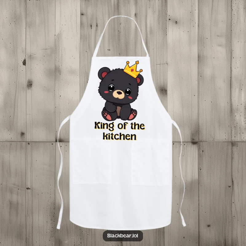 Funny apron with a black bear cub wearing a tiny crown and looking surprised, perfect for adding regal humor to cooking.