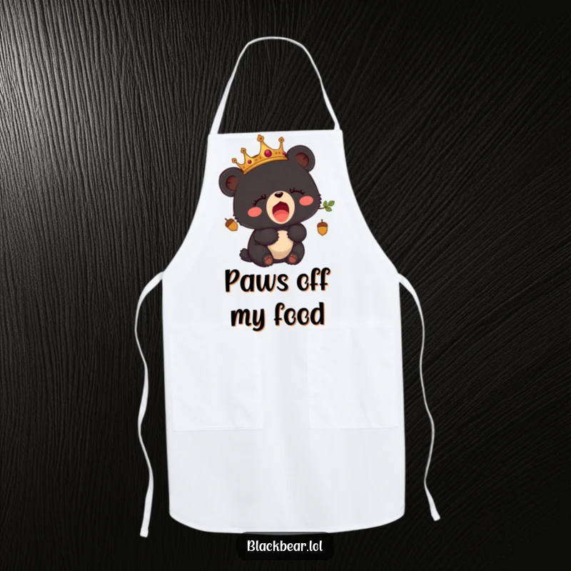 Funny apron featuring a sleepy black bear cub wearing an acorn crown and yawning.