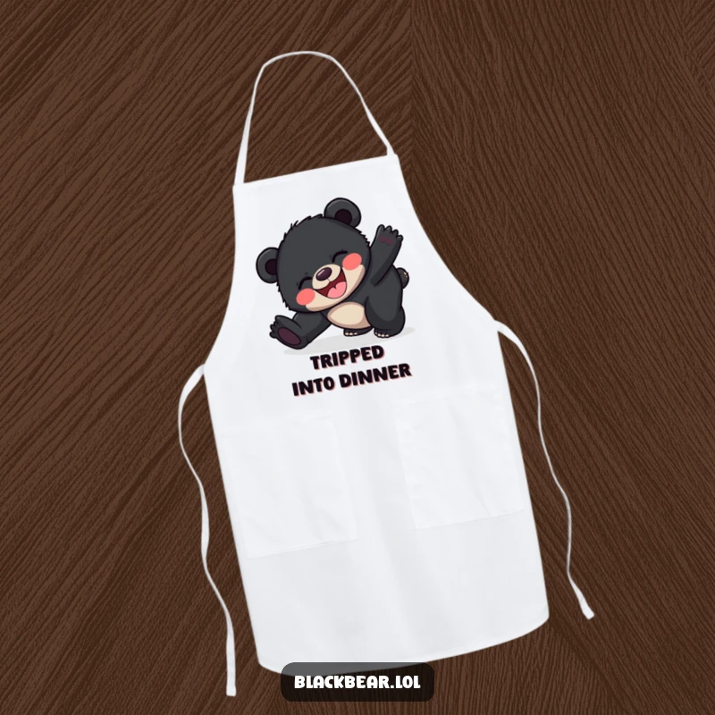 Funny happy black bear cub apron depicting a cub joyfully tripping, adding humor to kitchen tasks.