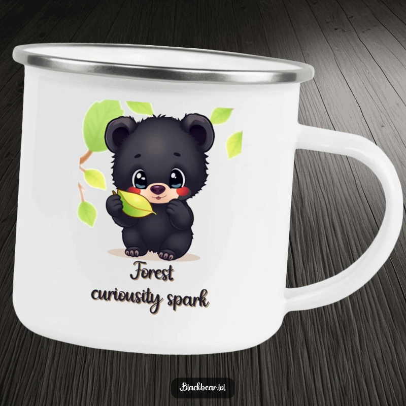Funny camping mug featuring a black bear cub with wide, curious eyes, looking intently at a shimmering leaf, for outdoor enjoyment.