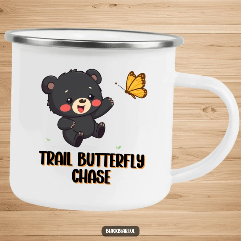 Funny camping mug showing a black bear cub happily chasing a butterfly, perfect for outdoor enjoyment with a touch of fun.