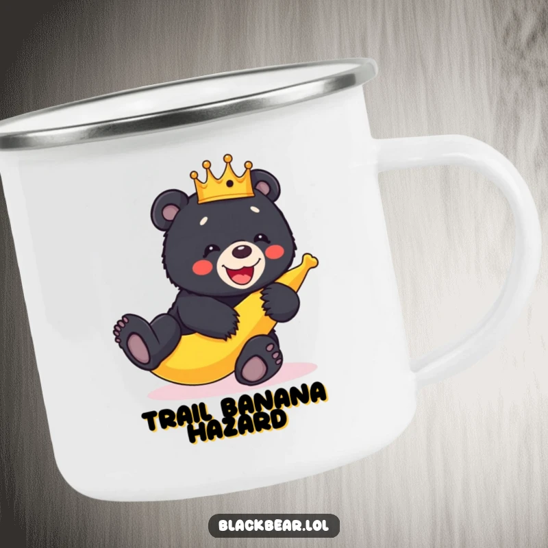Funny crowned black bear cub hilariously slipping on a banana peel, perfect for outdoor adventures on this camping mug.