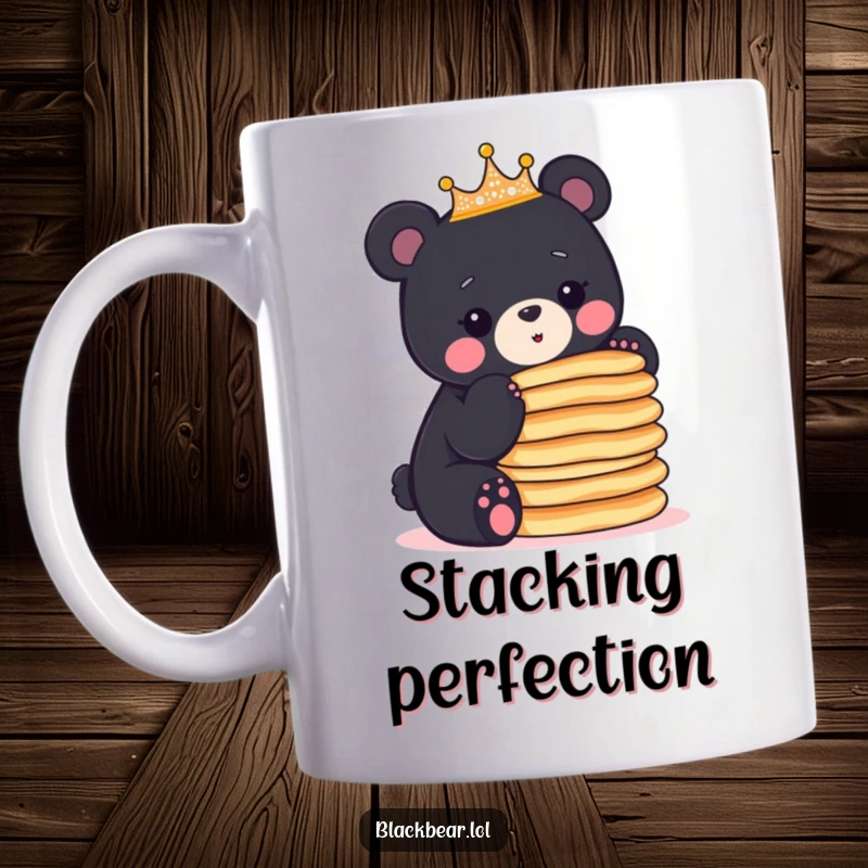 Funny black bear cub wearing a sparkly crown expertly balances a tall stack of pancakes on this humorous mug.