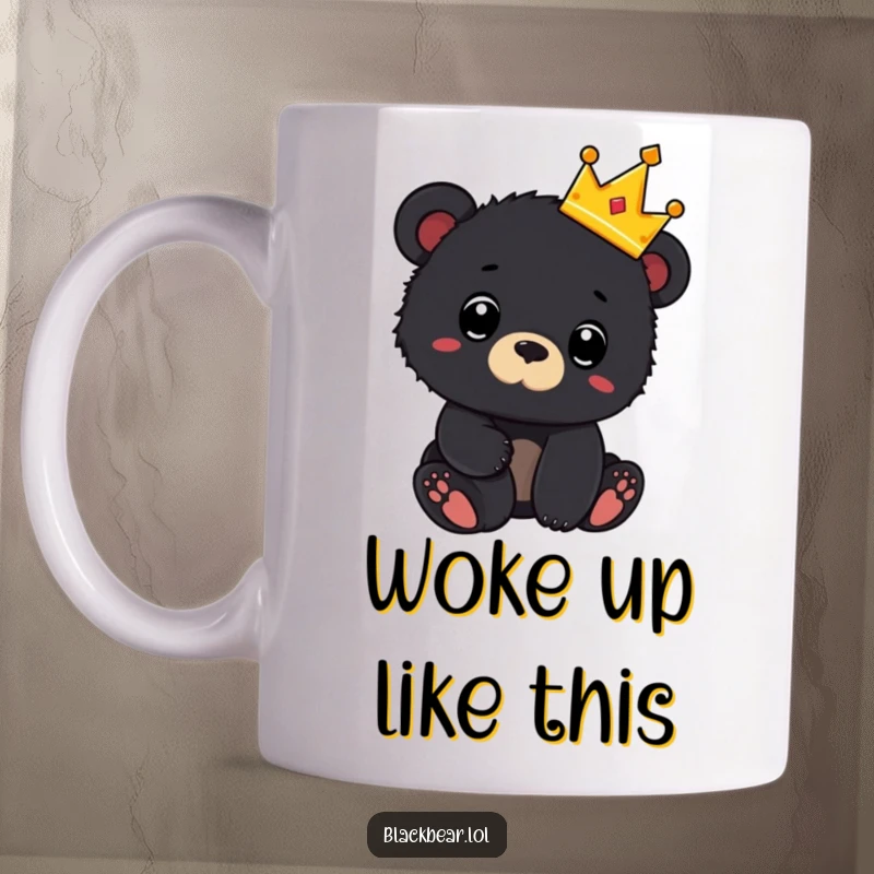 Funny mug showing a black bear cub wearing a tiny crown and looking surprised, exuding adorable royalty and shock.