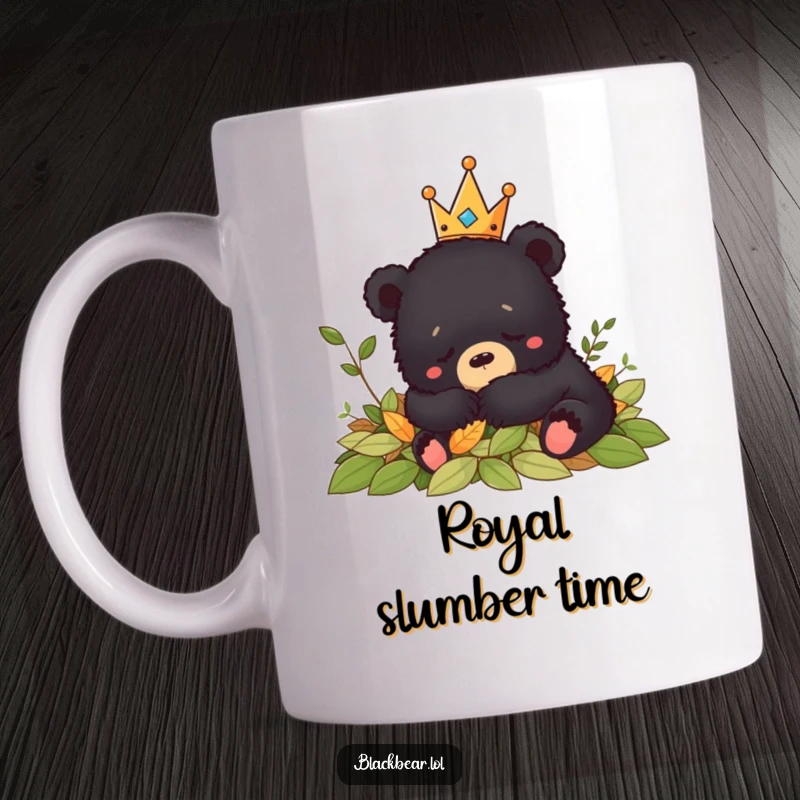 Funny black bear cub wearing a crown naps contentedly in a pile of autumn leaves on this relaxing mug.