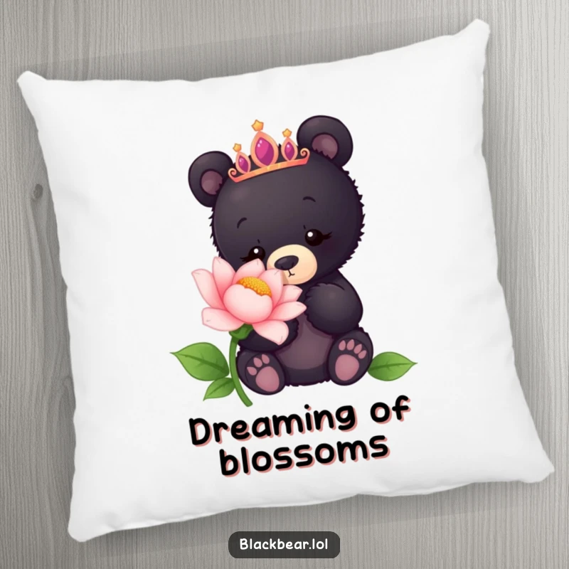 Funny pillow featuring a black bear cub wearing a tiara, curiously sniffing a giant flower, perfect for cozy decor.