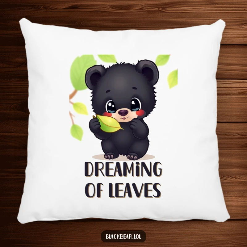 Funny pillow featuring a black bear cub with large, curious eyes, intently looking at a shimmering leaf, perfect for relaxing.