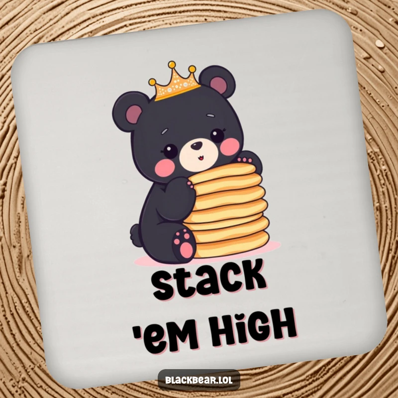 Funny crowned black bear cub balancing a stack of pancakes, adding breakfast-themed humor to this drink coaster.