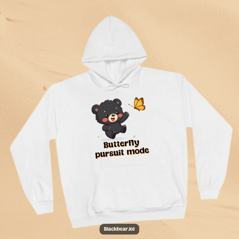 Funny hoodie showing a happy black bear cub chasing a butterfly, providing warmth and a cheerful, playful vibe.