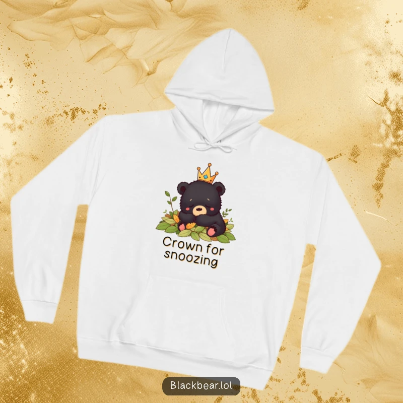 Funny crowned black bear cub sleeping peacefully in autumn leaves, embodying coziness on this warm hoodie.