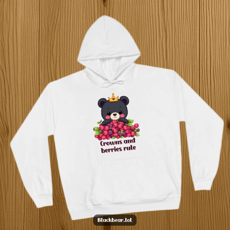 Funny hoodie showcasing a cute black bear with a crown peeking over a berry bush, offering warmth and a touch of royal humor.