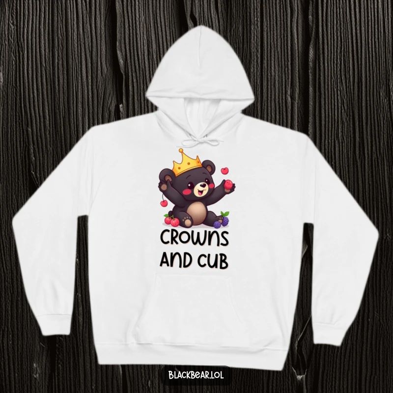 Funny Bear Cub Hoodie: Black bear cub with a crown playfully juggles berries, offering warmth and delightful entertainment.