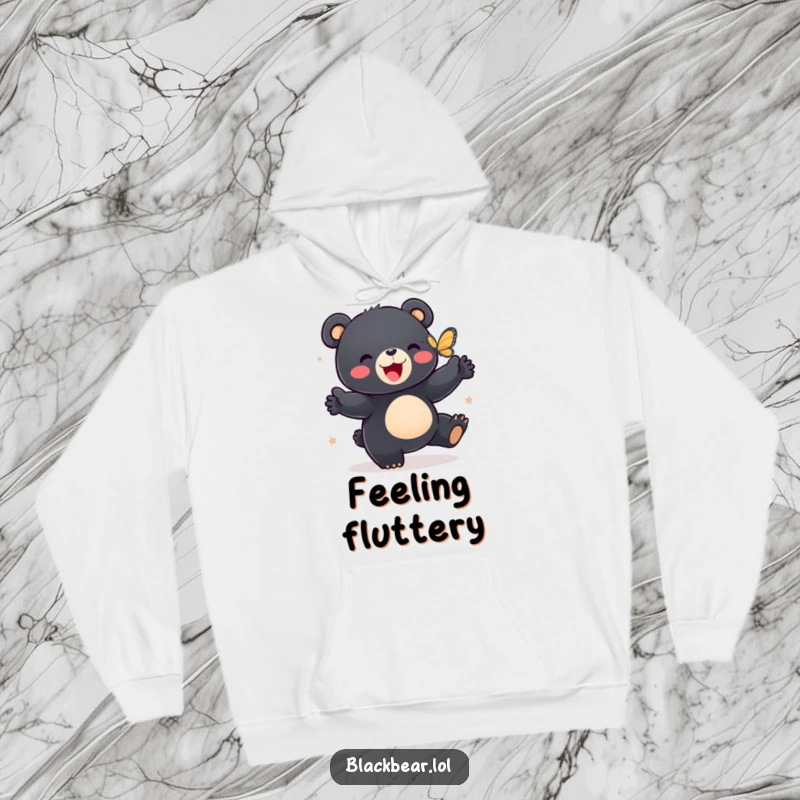 Funny hoodie depicting a black bear cub enthusiastically dancing with a butterfly, embodying pure, unadulterated fun.
