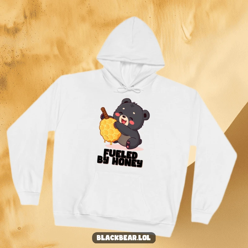 Funny small black bear cub tumbling happily with a giant honeycomb on a warm hoodie. Adorable and humorous forest creature.