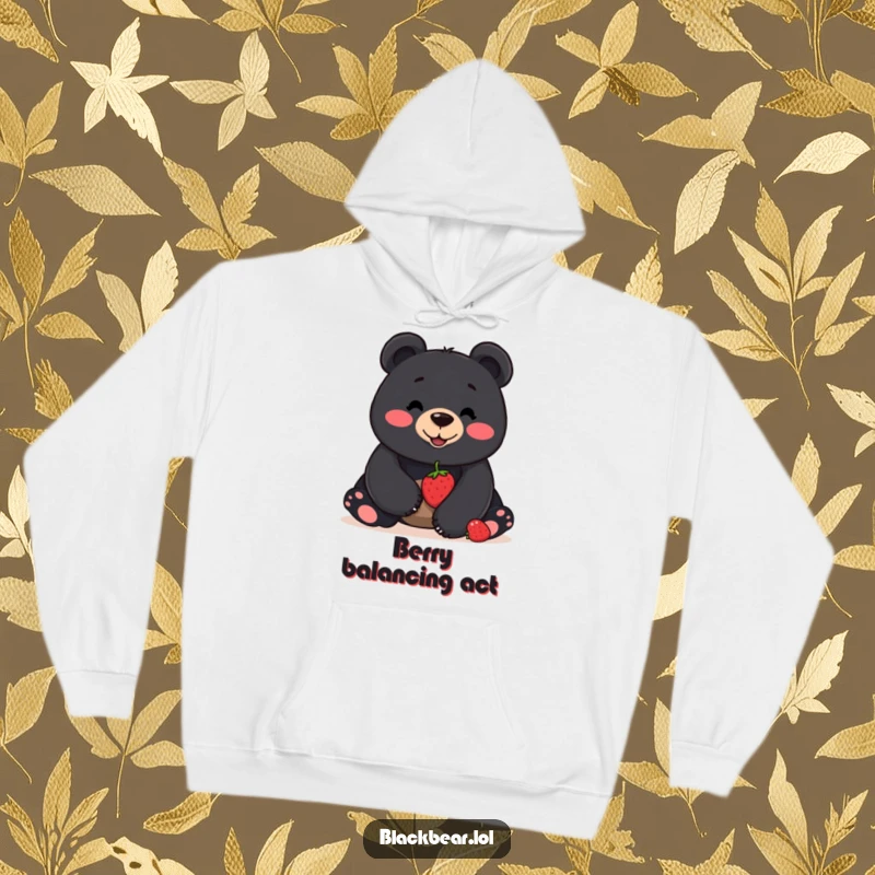Funny hoodie featuring a smiling black bear balancing a berry on its nose, offering warmth and a touch of playful skill.