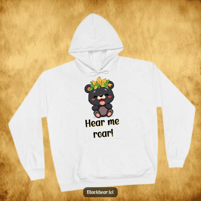 Cozy hoodie featuring a cute black bear cub with a leaf crown, letting out a playful roar, perfect for little adventurers.