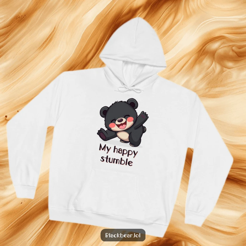 Funny happy black bear cub hoodie depicting a cub joyfully tripping over its feet, a symbol of exuberant happiness.