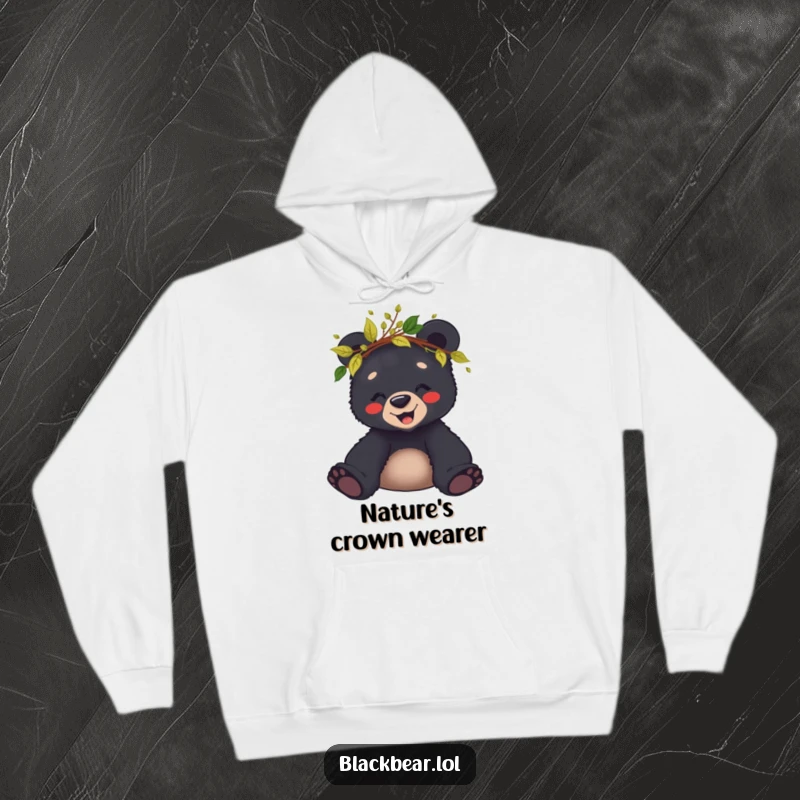 Funny hoodie featuring a giggling black bear cub wearing a crown of leaves and twigs, perfect for cozy outdoor vibes.