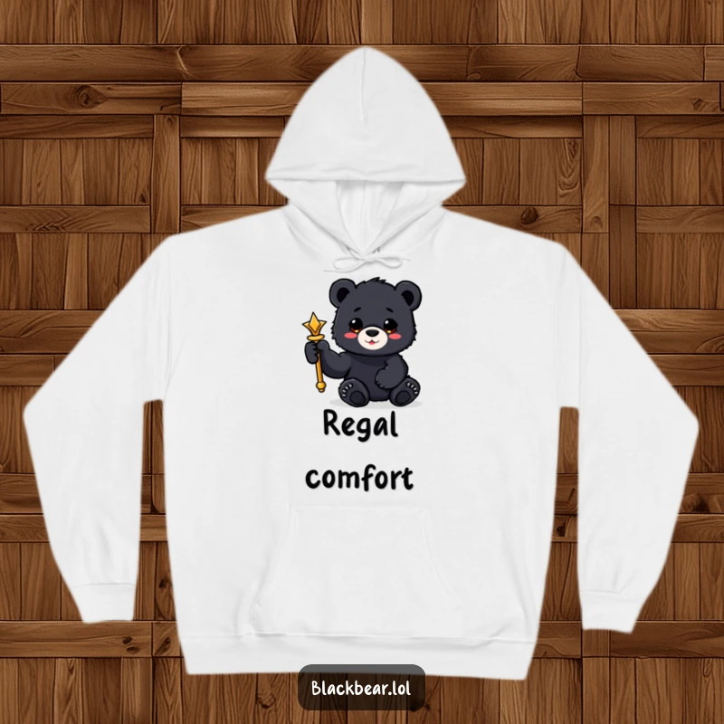 Funny black bear cub hoodie holding a shiny scepter with a paw, regal and cozy wear.