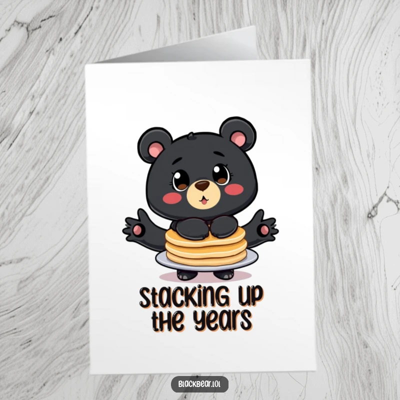 Funny Free Printable Birthday Card: Stylized black bear with big eyes balancing a tall stack of pancakes, humorous.