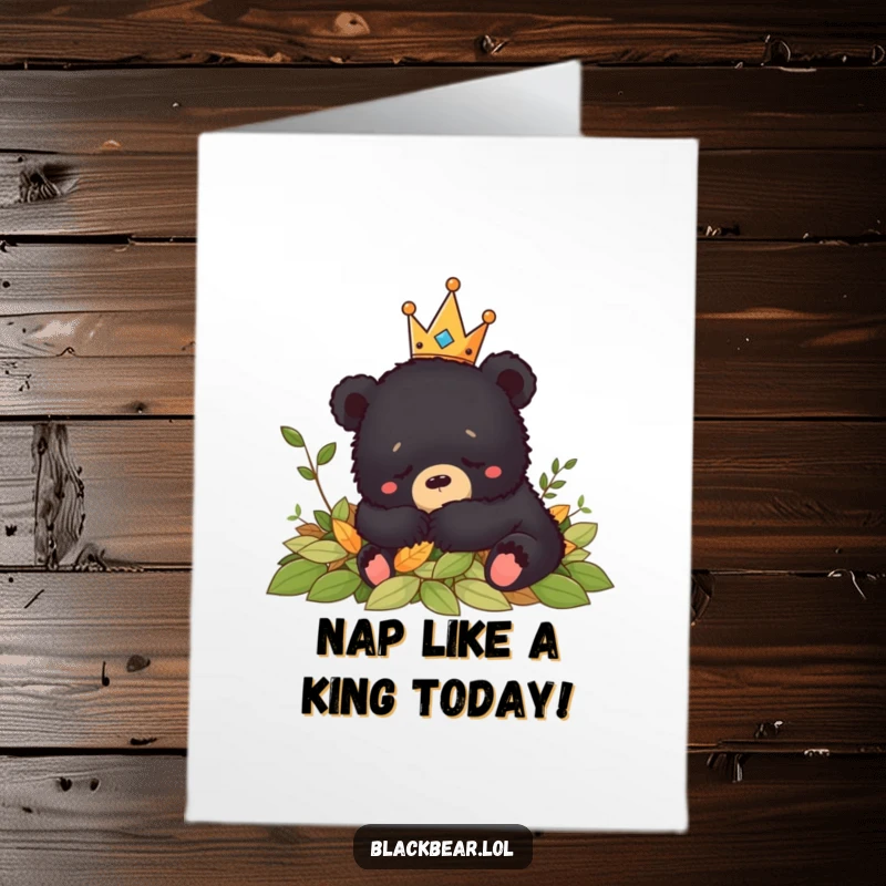 Funny Free Printable Birthday Card: Content black bear cub wearing a crown naps soundly in a pile of autumn leaves.