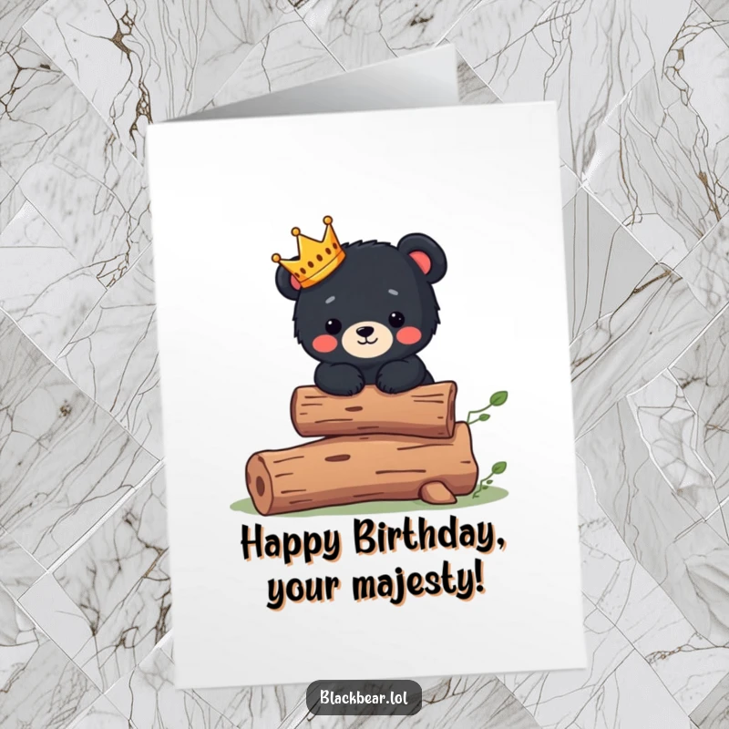 Cute Free Printable Birthday Card featuring a black bear cub wearing a tiny crown, balancing regally on a log, fit for royalty.