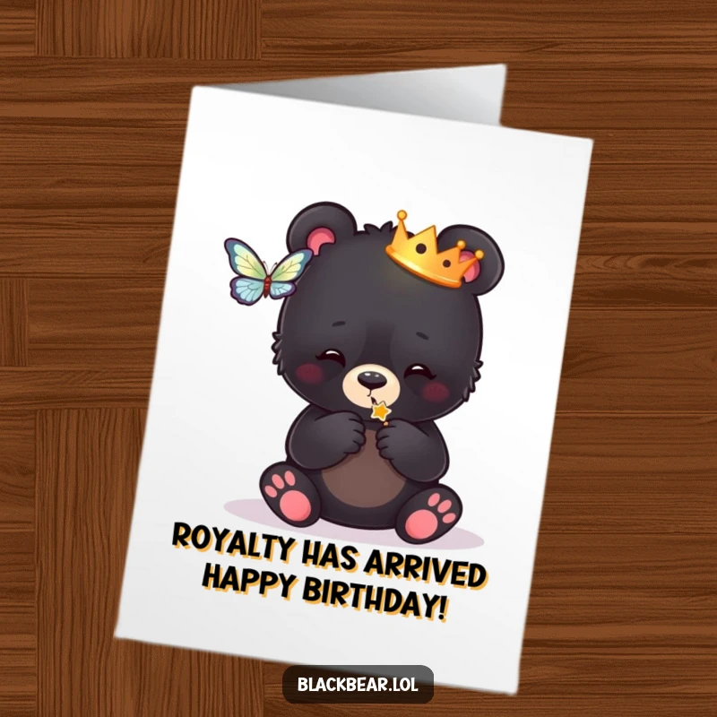 Funny Free Printable Birthday Card: Black bear cub in crown playfully batting at a butterfly, ready for birthday fun.