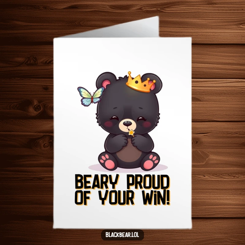 Funny Free Printable Congratulations Card: A regal black bear cub wearing a crown, batting at a butterfly, celebrating achievement.
