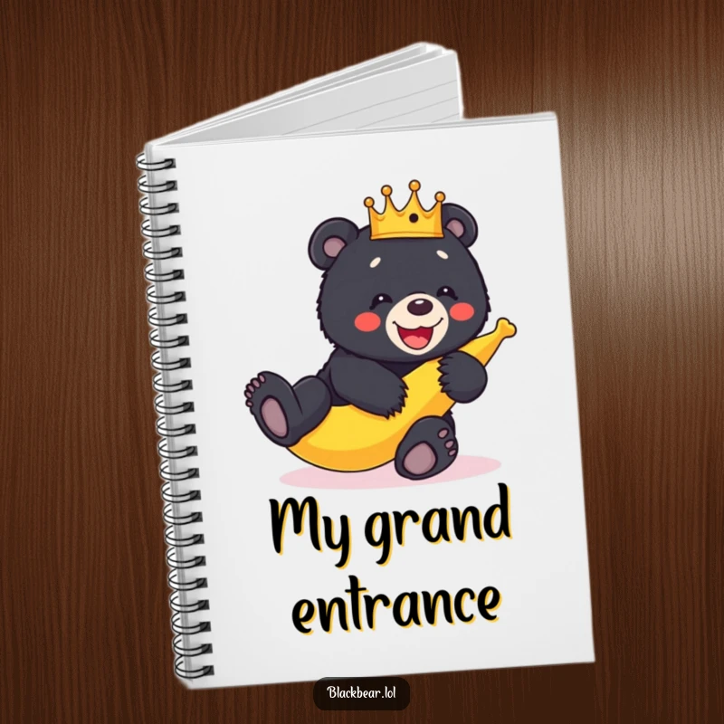 Funny crowned black bear cub slipping on a banana peel, depicted on the cover of a humorous notebook.