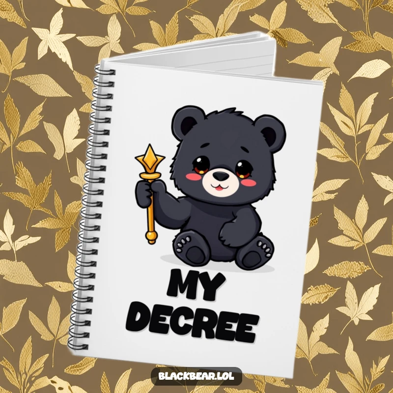 Funny black bear cub notebook holding a shiny scepter with a paw, for regal note-taking.