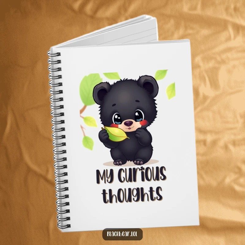 Funny notebook cover featuring a black bear cub with wide, curious eyes, examining a shimmering leaf, perfect for jotting down thoughts.