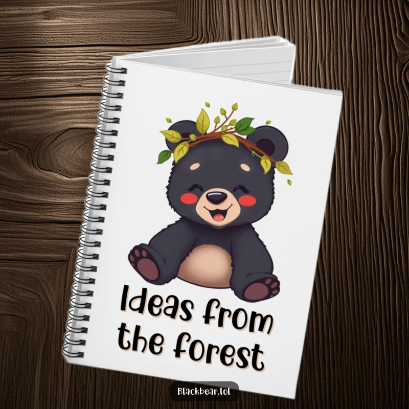Funny notebook featuring a giggling black bear cub wearing a crown of leaves and twigs, perfect for jotting ideas.