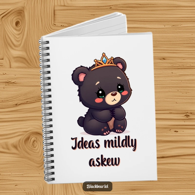 Funny black bear cub notebook with a tiara askew, looking confusedly delighted, for notes and sketches.