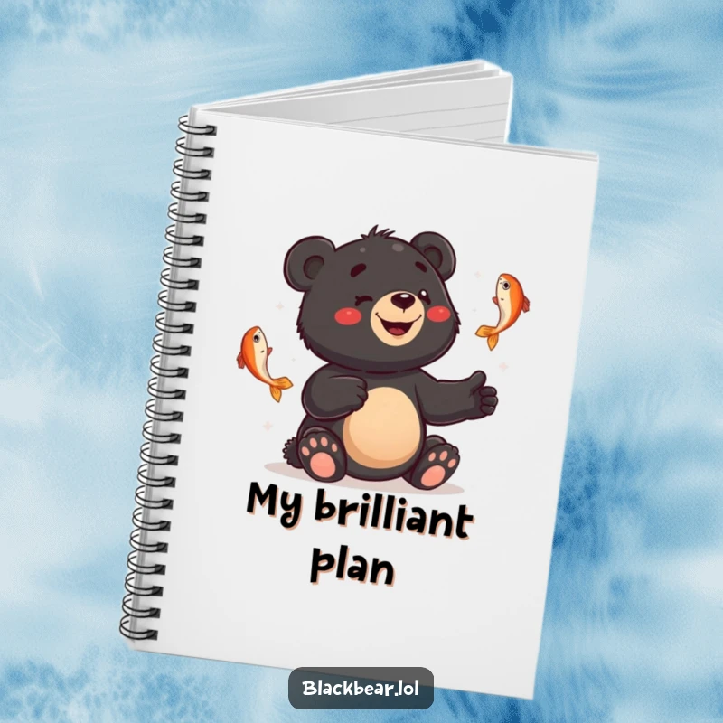Funny notebook featuring a smiling black bear cub juggling fish with a bewildered expression, ideal for note-taking with humor.