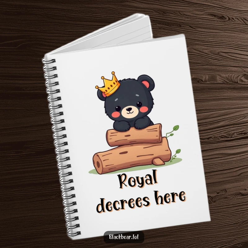 Funny Notebook: Cute black bear cub wearing a tiny crown balances on a log, perfect for jotting royal ideas.