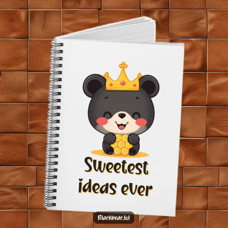 Funny notebook featuring a black bear cub wearing a tiny crown, balancing a honeycomb on its nose, ideal for jotting down ideas.
