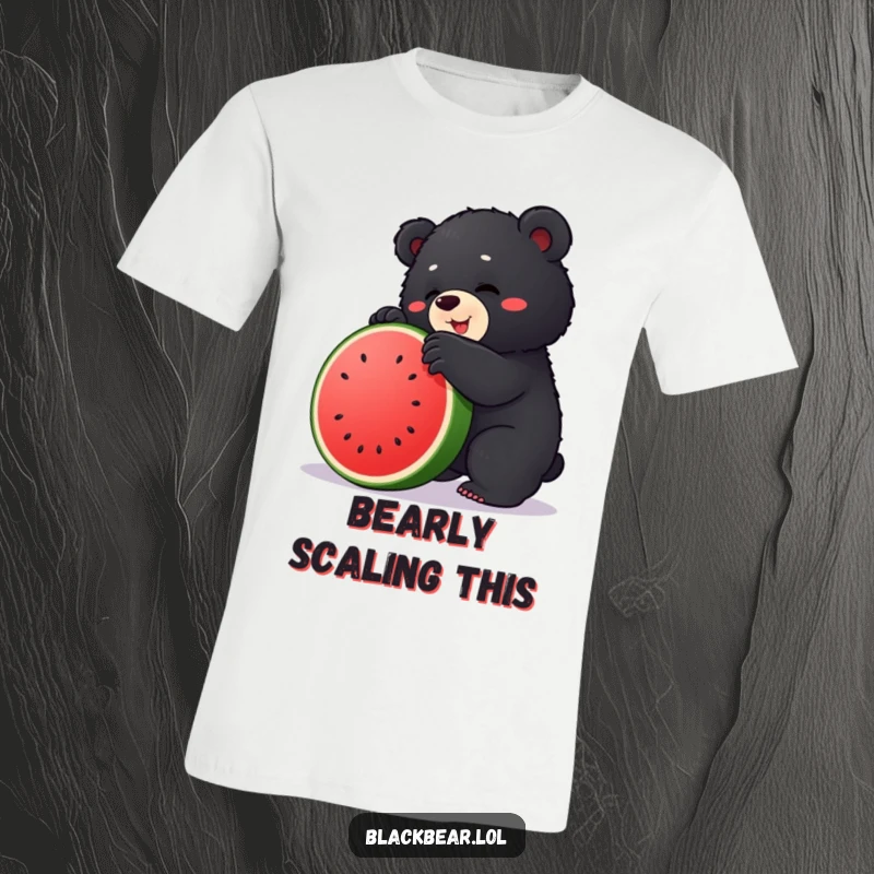 Funny t-shirt featuring an adorable chubby black bear cub struggling comically to climb a large, green watermelon.