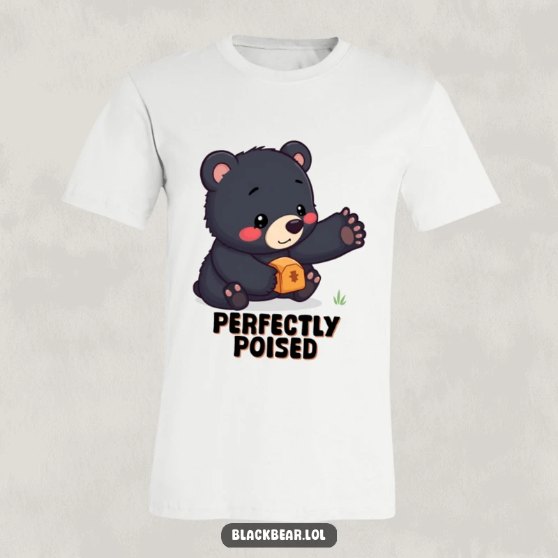 Funny t-shirt showcasing a charming black bear cub concentrating intensely while balancing a precious treasure atop its nose, looking quite pleased.