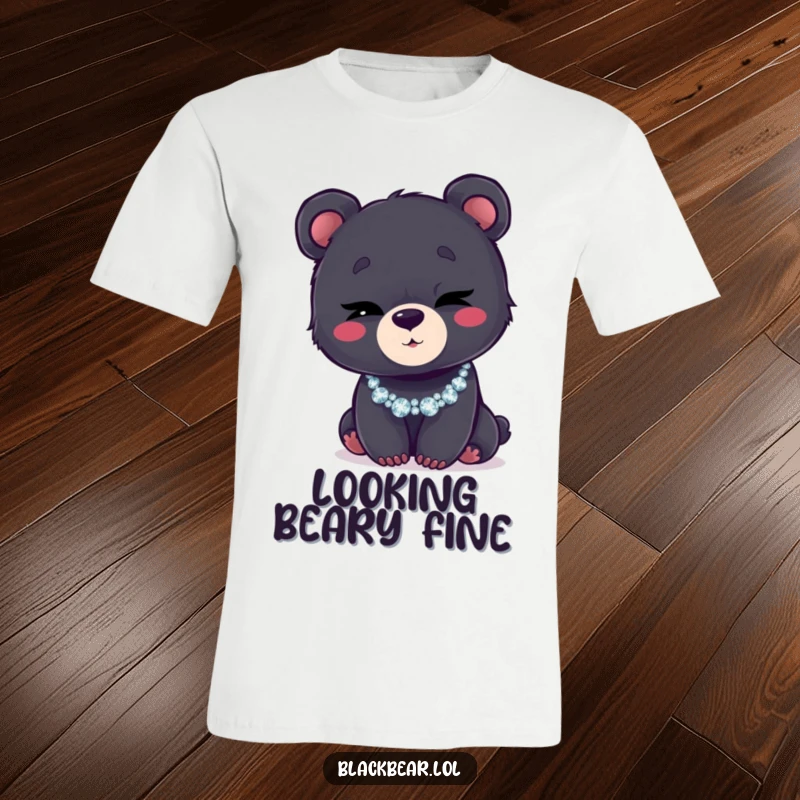 Funny t-shirt showing a black bear cub winking with a mischievous glint, wearing a sparkly, glittering necklace.