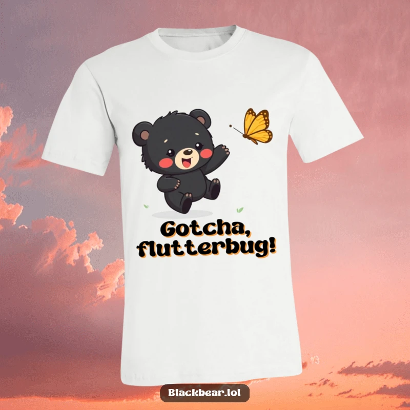 Funny t-shirt featuring a cute black bear cub happily running after a fluttering butterfly, symbolizing carefree fun and playful energy.