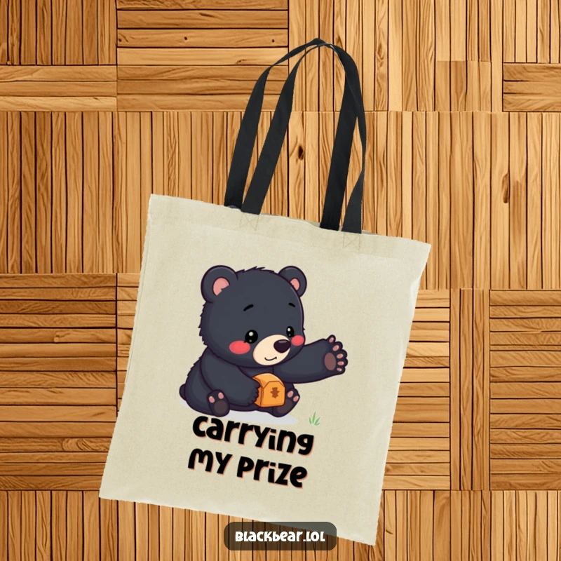 Funny tote bag featuring a black bear cub masterfully balancing a small treasure on its nose, ready to carry your essentials with charm.