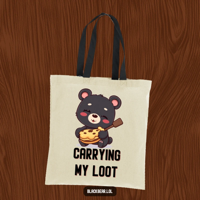 Funny Tote Bag print of a winking black bear cub proudly holding a stolen pie, showcasing sweet mischief.