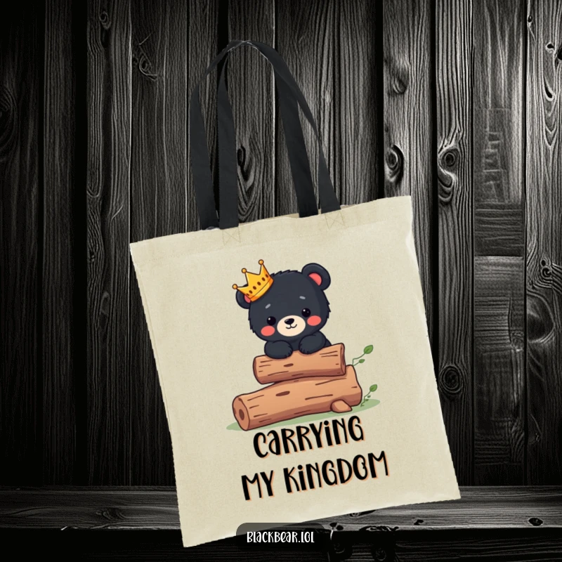 Funny Tote Bag: Cute black bear cub wearing a tiny crown balances on a log, symbolizing cute royalty.