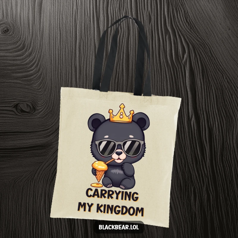 Funny Tote Bag: A regal black bear cub wearing a crown and sunglasses, tasting honey from a cone, ready for any royal outing.